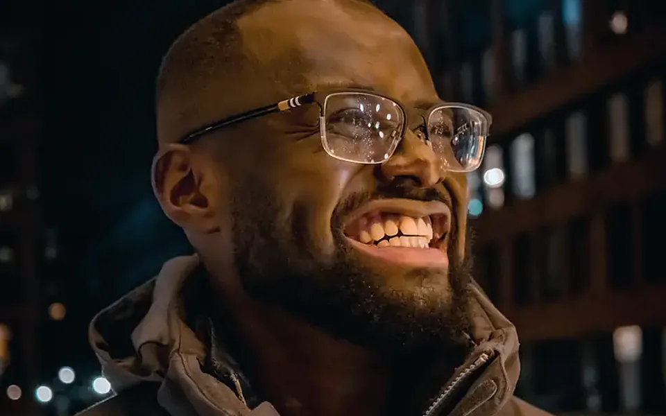 Patient smiling confidently after denture treatment