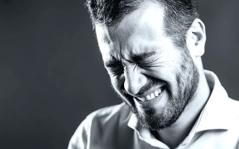 Patient holding their jaw in dental pain