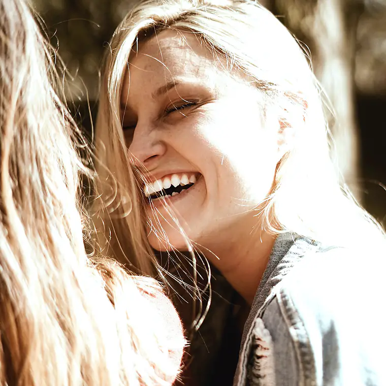 Patient laughing in warm natural light