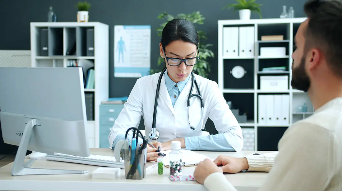 Dentist and patient reviewing an implant plan on screen